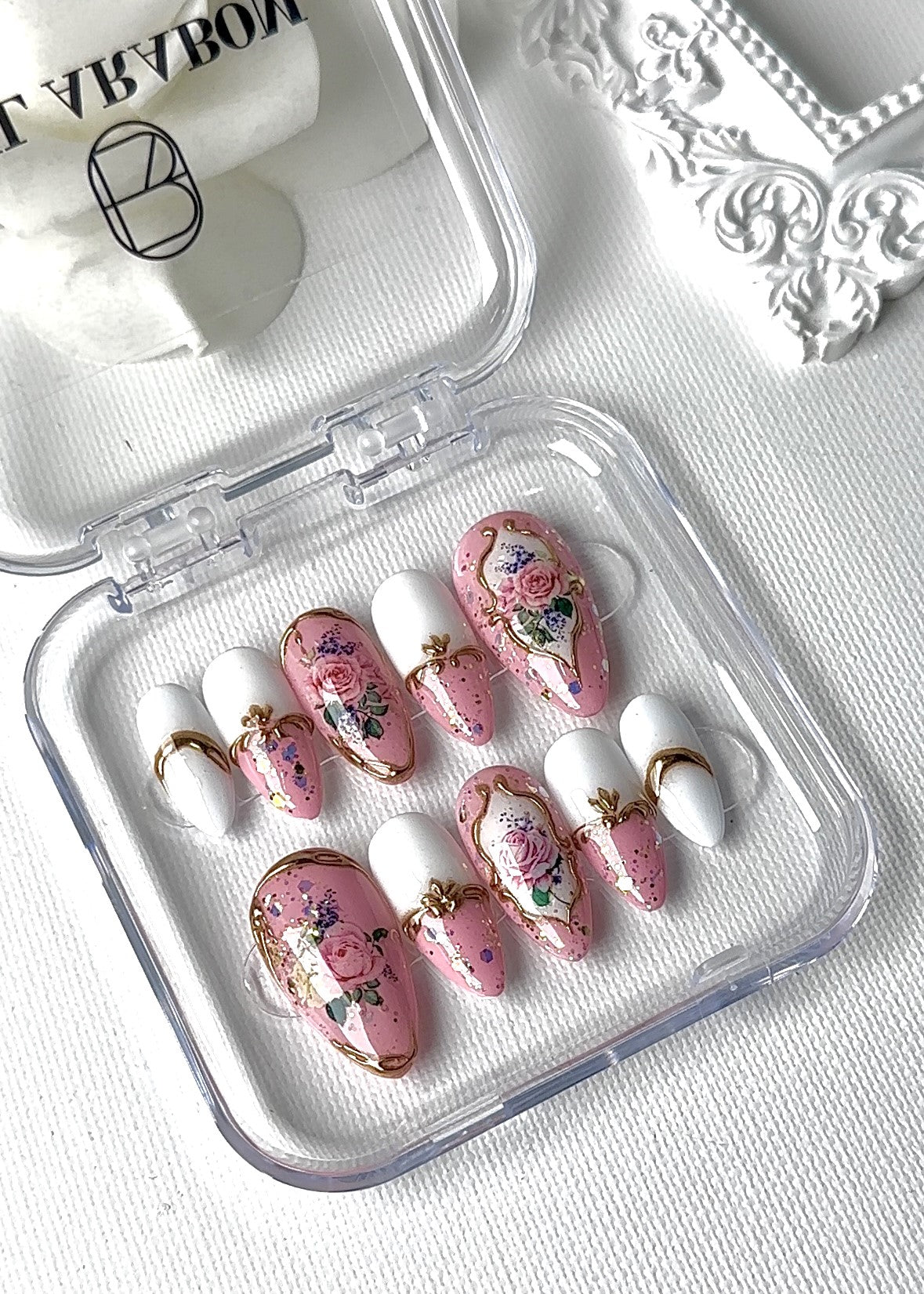 Close-up view of English Rose Garden press-on nails featuring elegant and detail-oriented design Front image with case