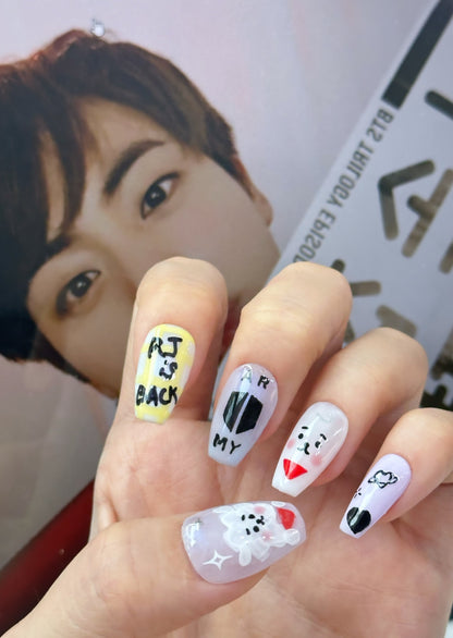 BTS-inspired handmade press-on nails with unique designs for ARMY fans, showcasing high-quality and durable materials.