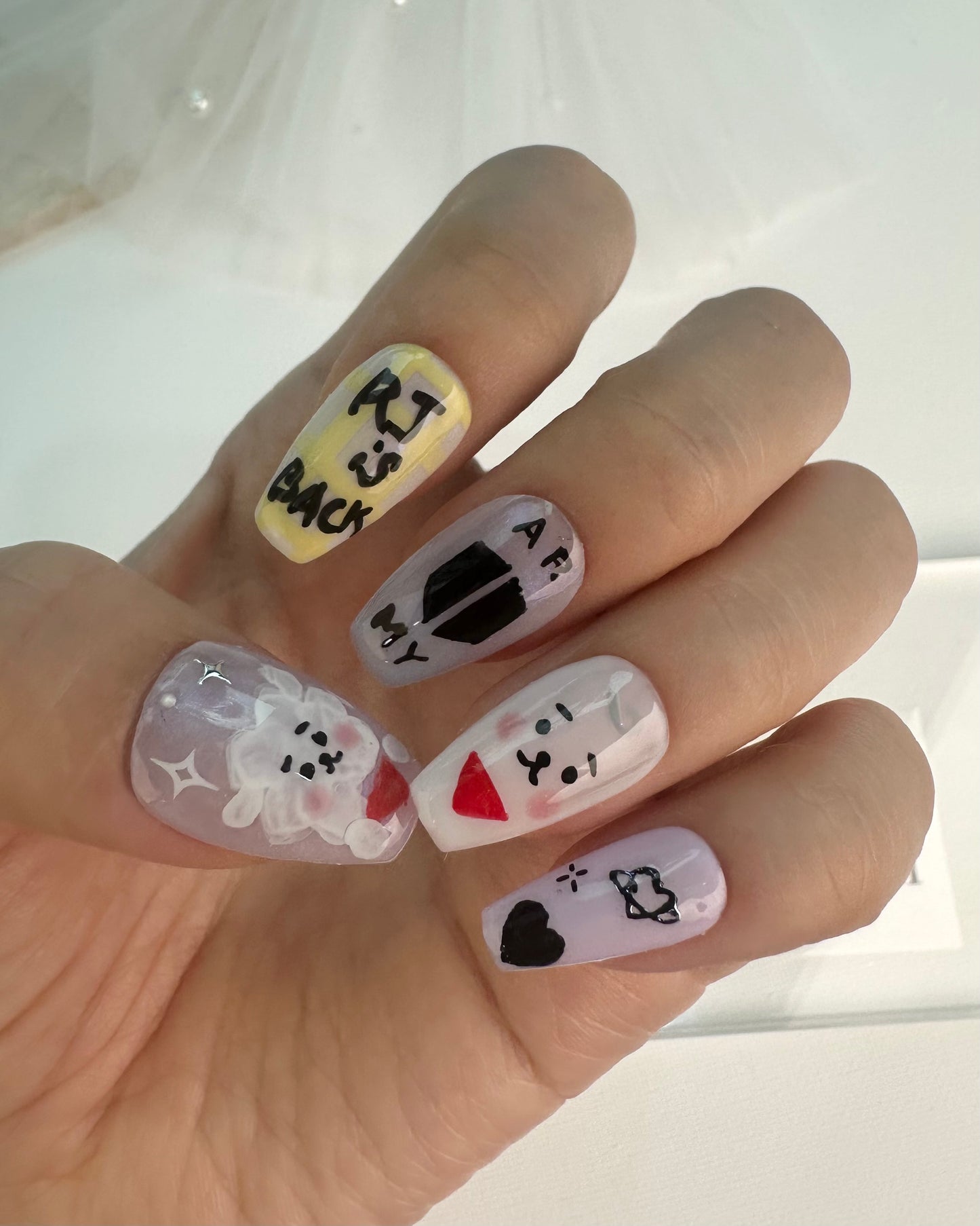 BTS-inspired handmade press-on nails with unique designs for ARMY fans, showcasing high-quality and durable materials.